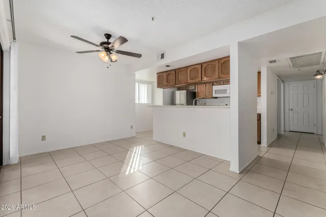 a view of a room with window and a ceiling fan