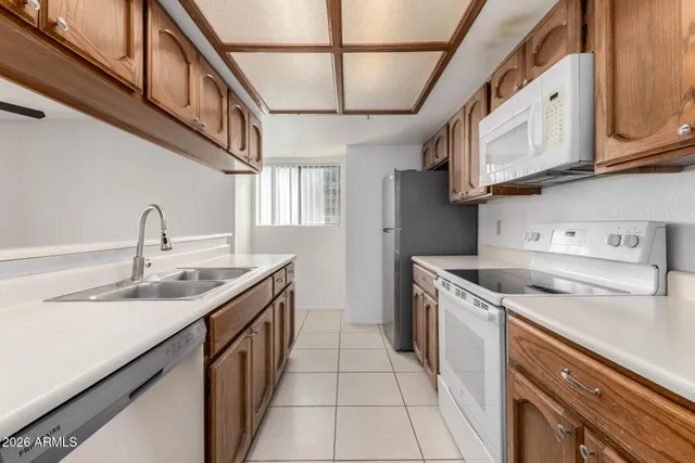 a kitchen with stainless steel appliances granite countertop a sink and dishwasher a stove top oven with wooden floor