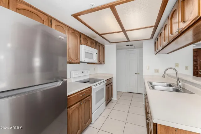 a kitchen with stainless steel appliances granite countertop a refrigerator and a sink