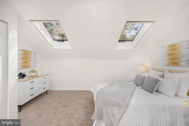 a bedroom with a bed and a night stand