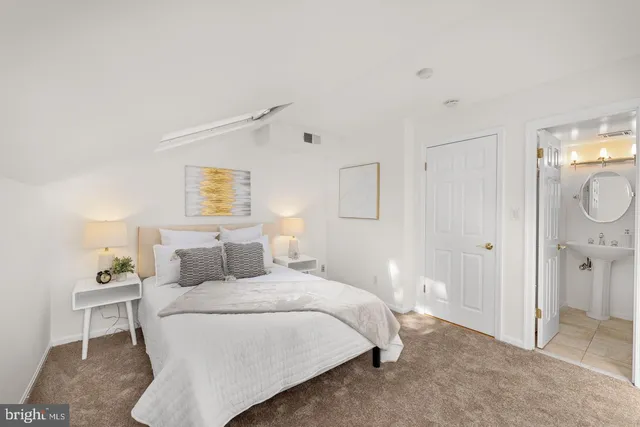 a bedroom with a bed and a lamp