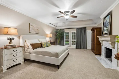 a spacious bedroom with a large bed and a chandelier