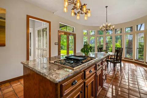 a view of a dining room with furniture a chandelier and wooden floor