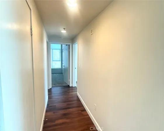 a view of hallway with wooden floor