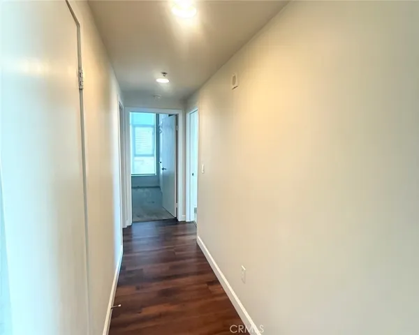 a view of hallway with wooden floor
