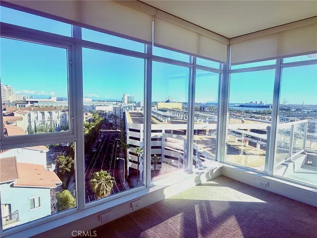 a living room filled with furniture and a floor to ceiling window