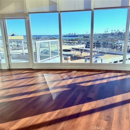 a view of a living room with a floor to ceiling window and floor