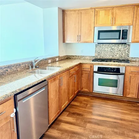 a kitchen with stainless steel appliances granite countertop a stove and a microwave