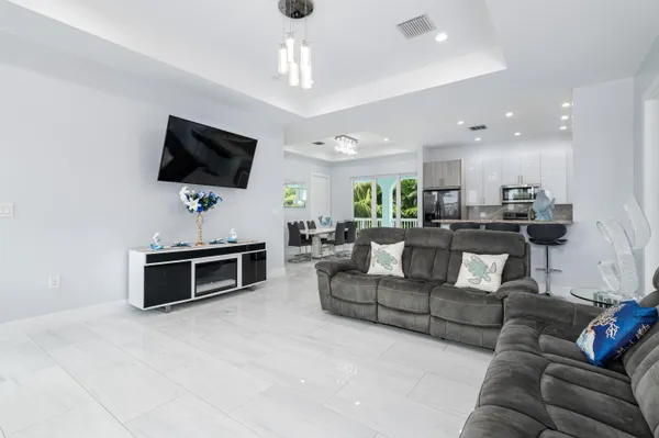 a kitchen with a sink a microwave a stove and refrigerator