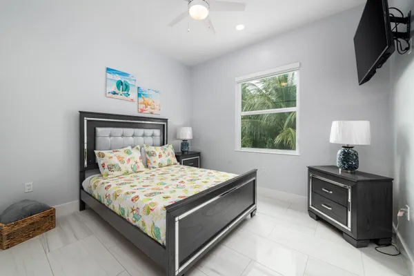 a bedroom with a bed and a flat screen tv