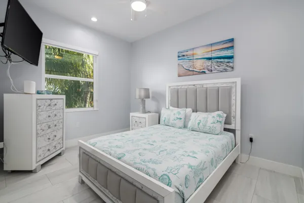 a bedroom with a bed and a flat screen tv