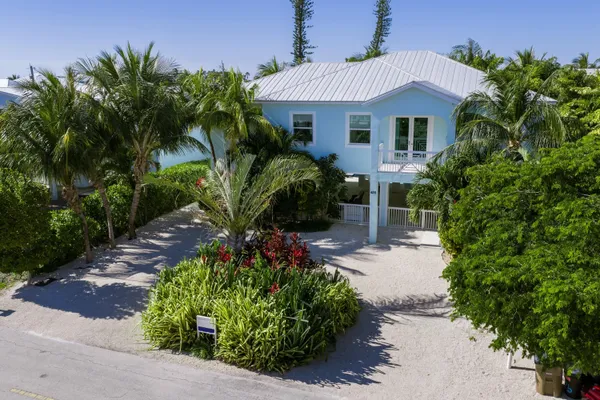 an aerial view of a house with garden space and street view