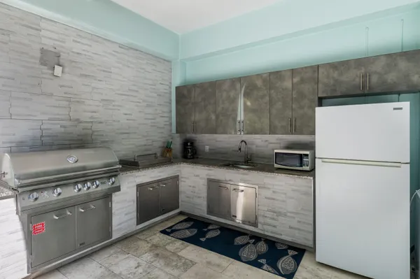 a kitchen with a stove a refrigerator and a sink