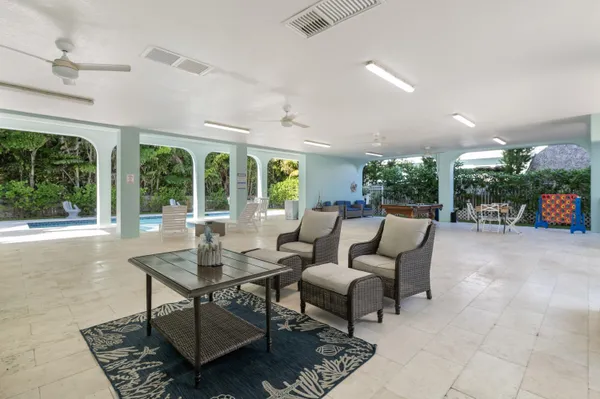 a living room with furniture and a floor to ceiling window