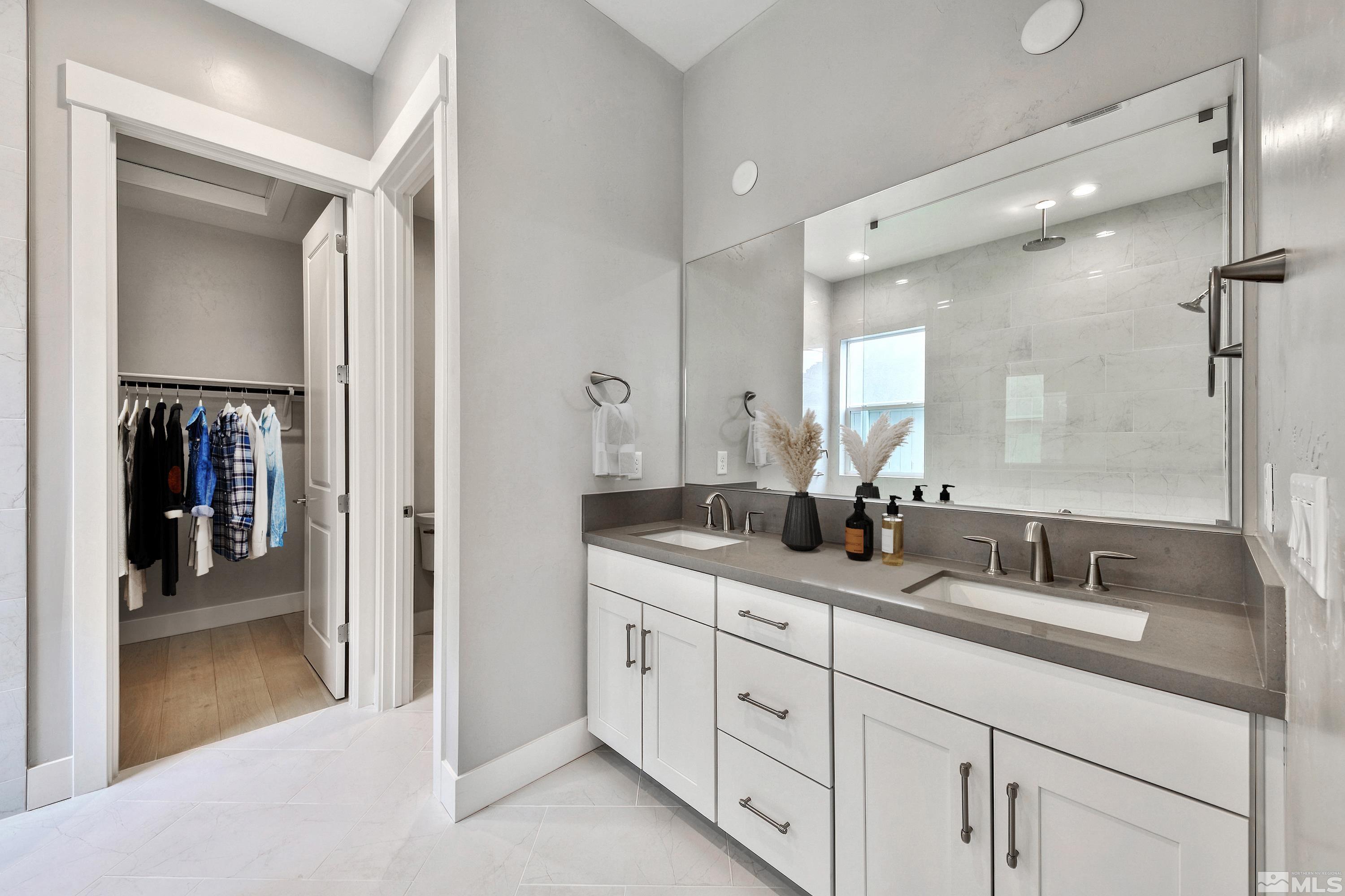637 Braided Rope Drive Reno, NV 89511 - Photo 11 of 25 a bathroom with double sink and a mirror