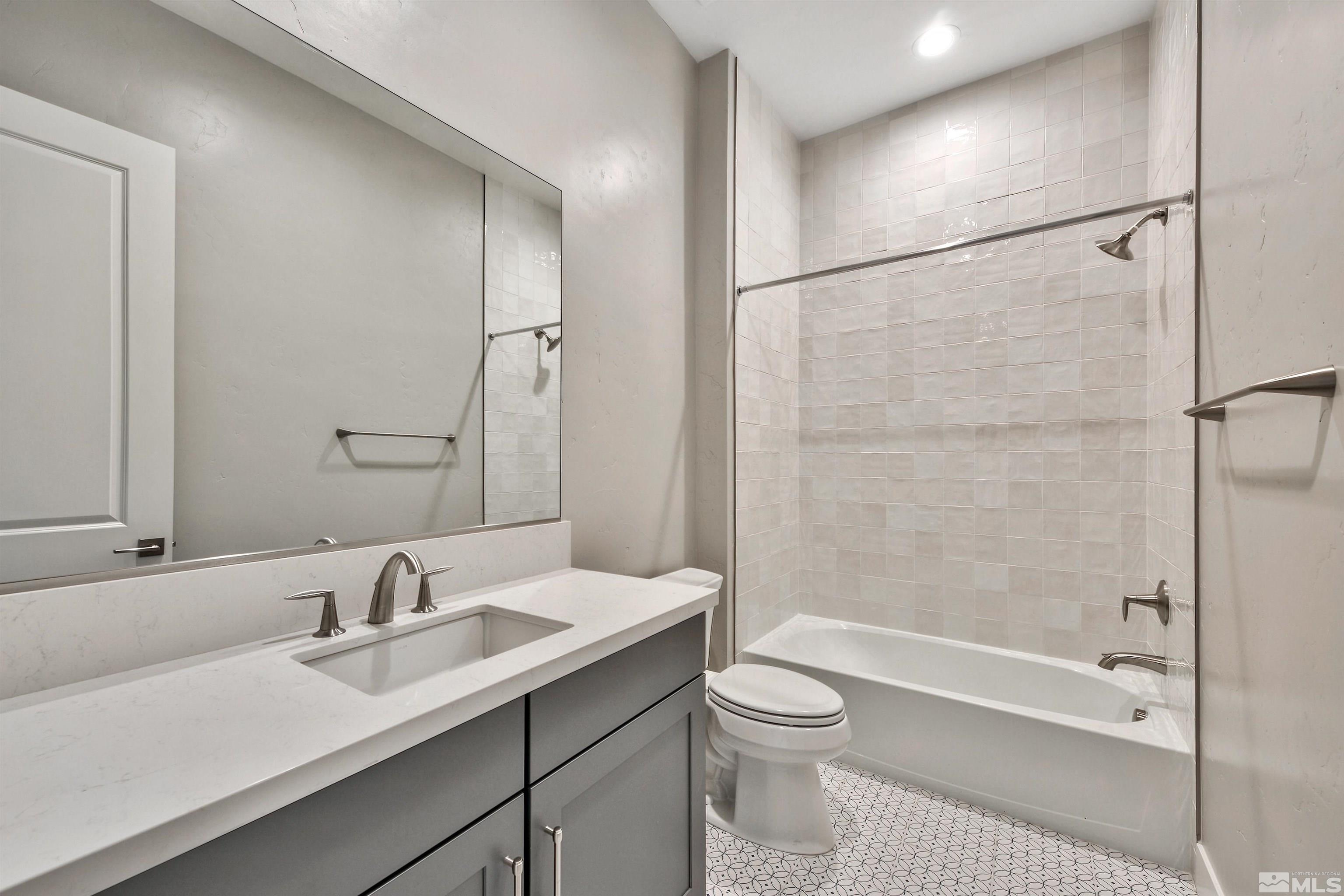 637 Braided Rope Drive Reno, NV 89511 - Photo 13 of 25 a bathroom with a granite countertop sink a toilet and shower