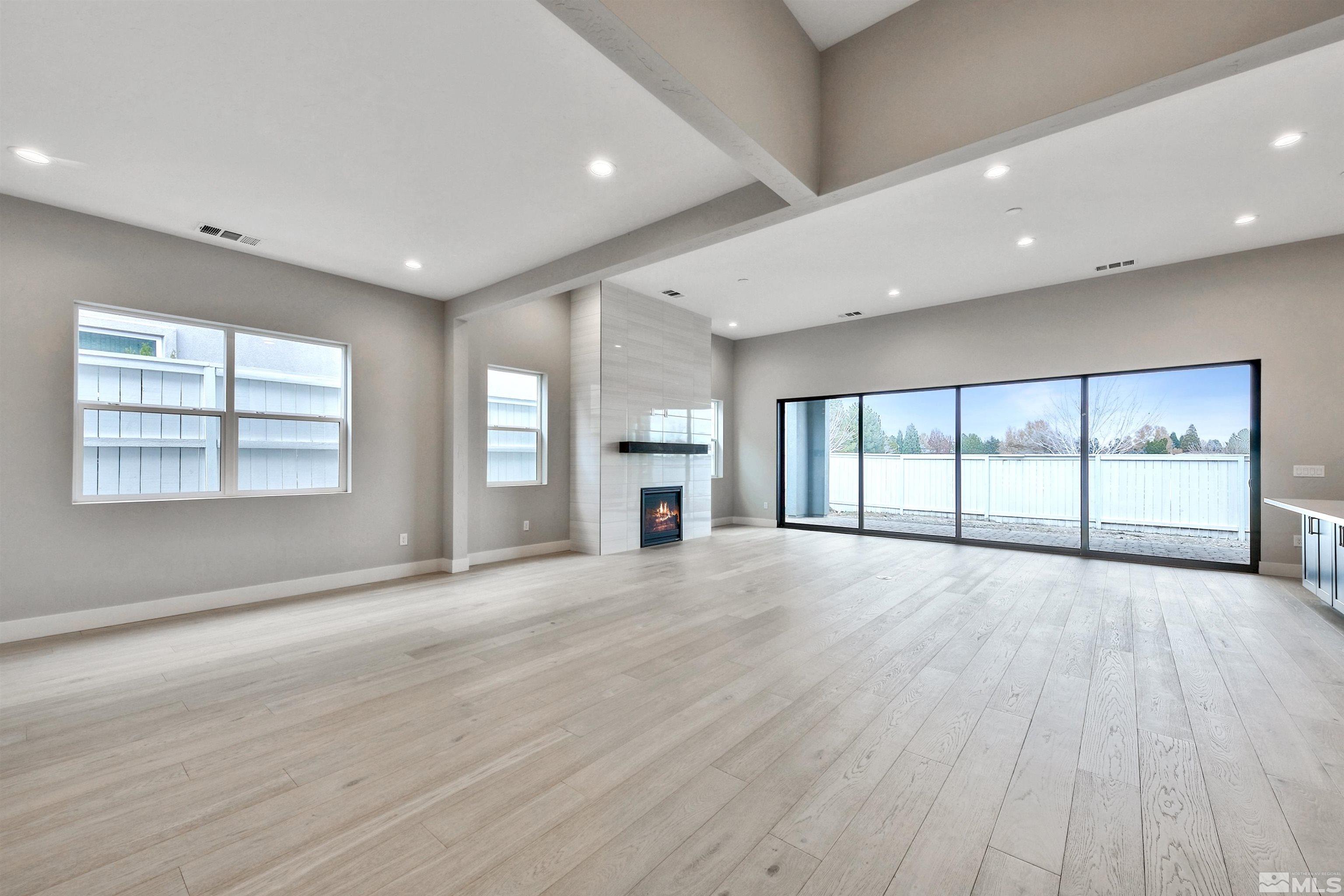 637 Braided Rope Drive Reno, NV 89511 - Photo 3 of 25 a view of an empty room with wooden floor and a window