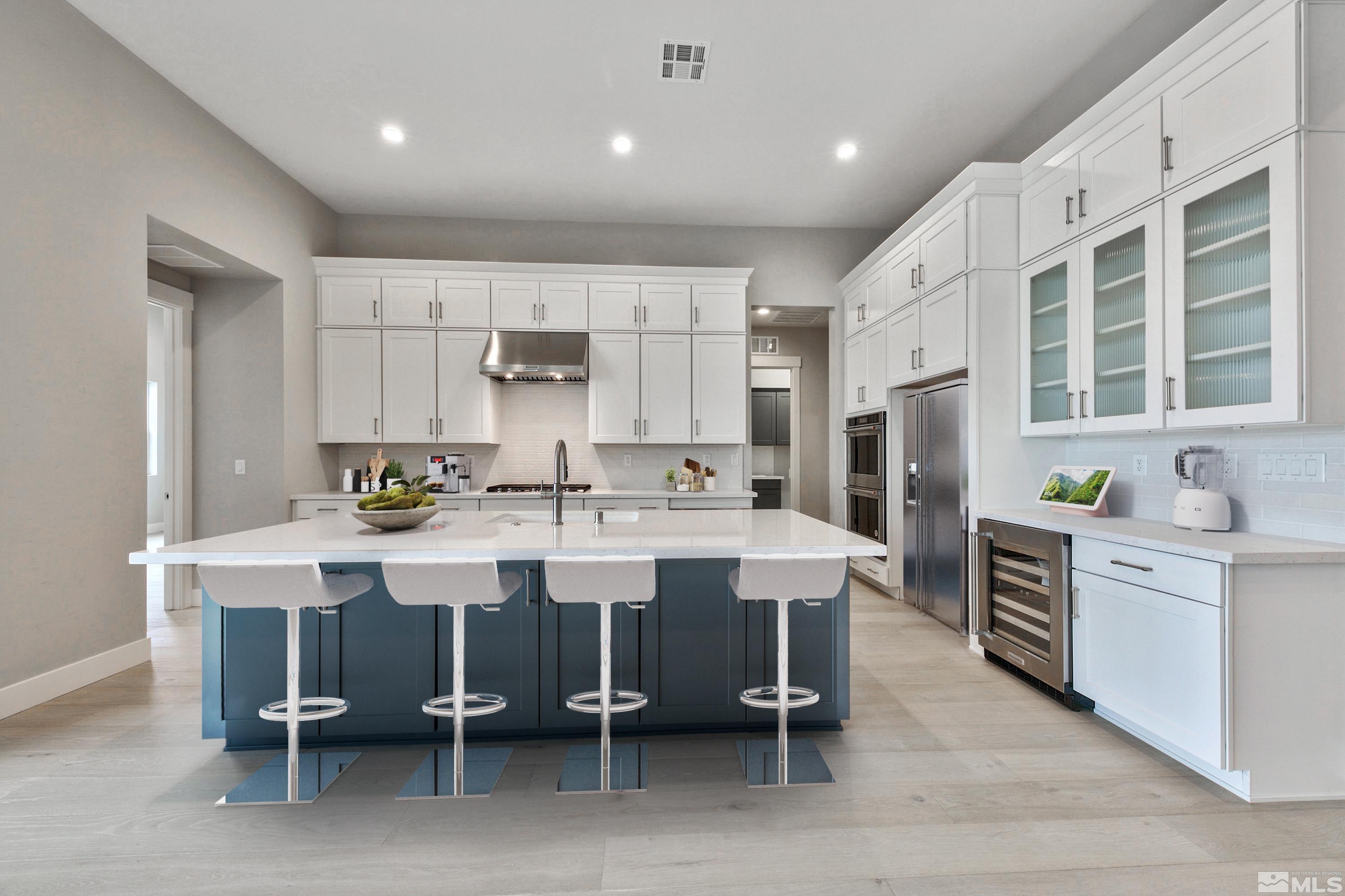 637 Braided Rope Drive Reno, NV 89511 - Photo 5 of 25 a kitchen with white cabinets and stainless steel appliances