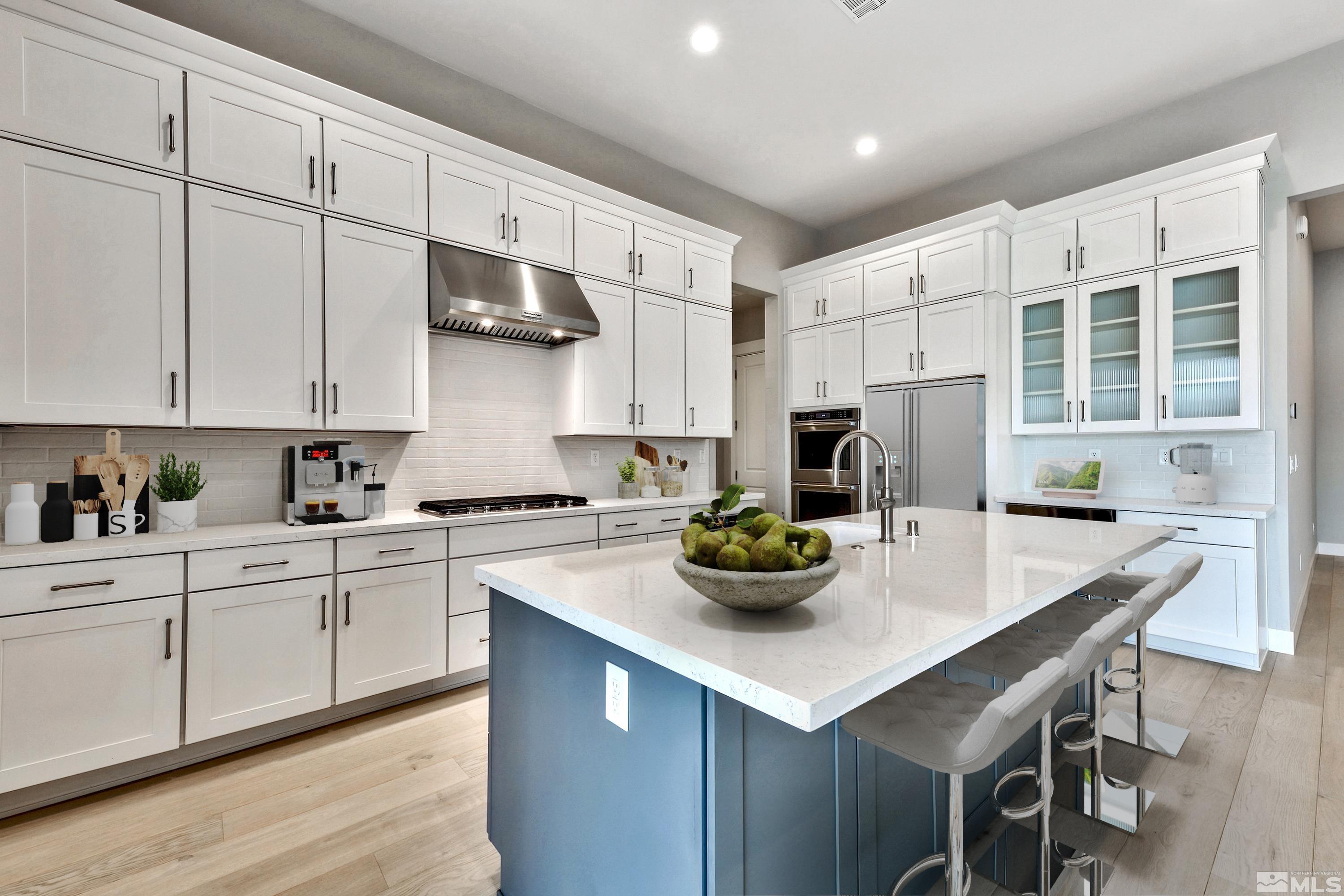637 Braided Rope Drive Reno, NV 89511 - Photo 6 of 25 a kitchen with stainless steel appliances a white table chairs and white cabinets