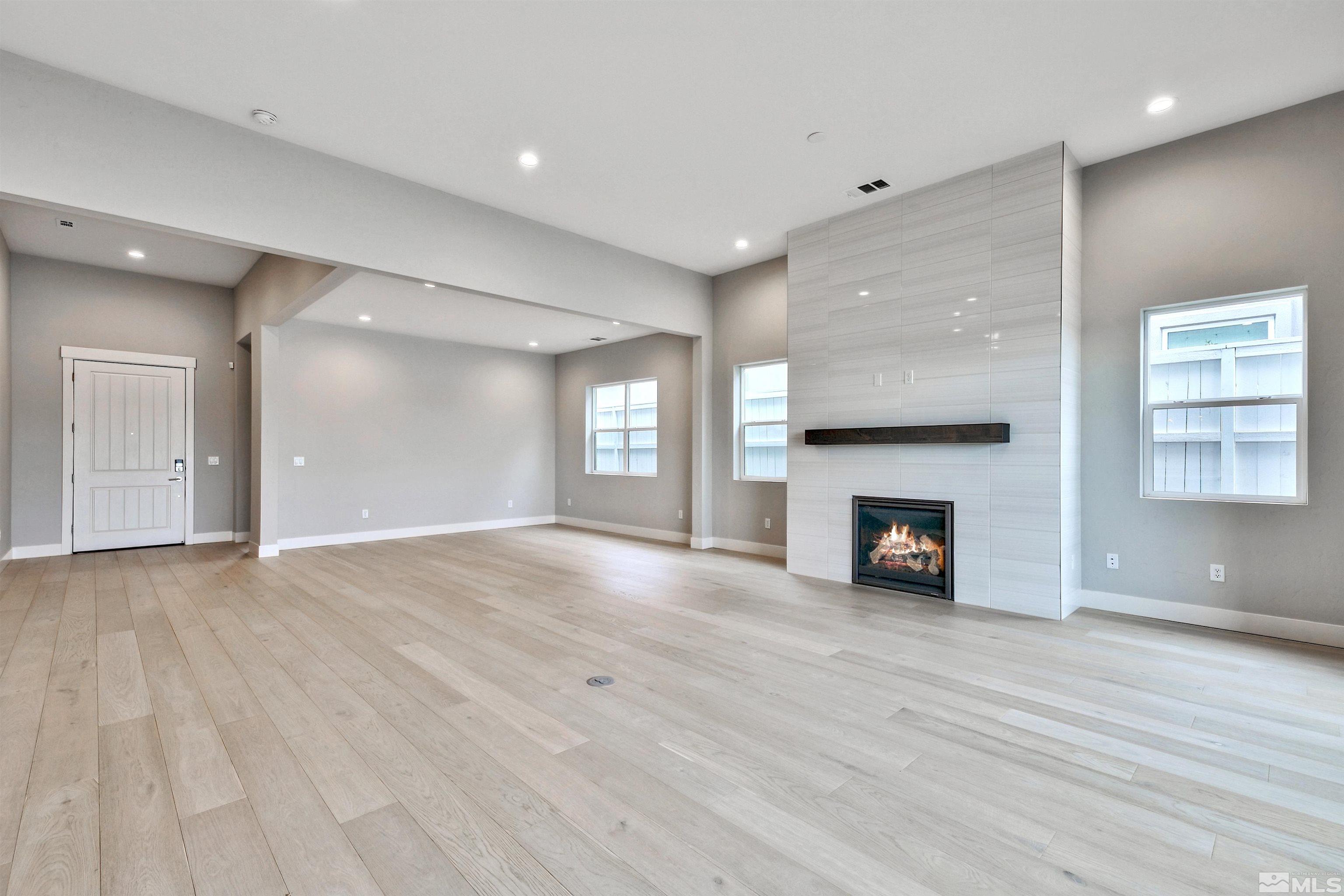 637 Braided Rope Drive Reno, NV 89511 - Photo 8 of 25 a view of an empty room with wooden floor fireplace and a window