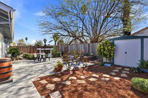 a view of a patio with table and chairs and potted plants