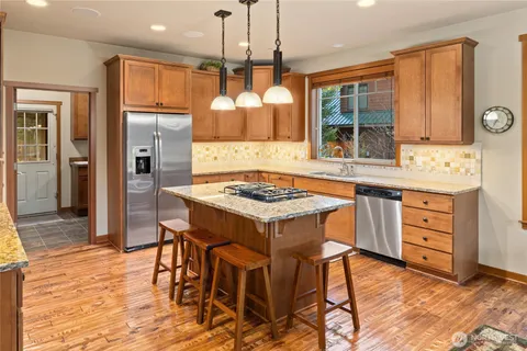 a kitchen with a table chairs sink and refrigerator