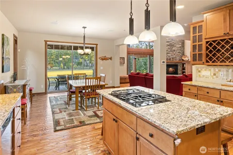 a kitchen island with a stove a table and chairs