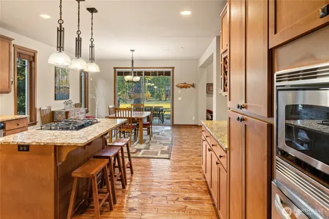 a view of a kitchen with dining table and chairs