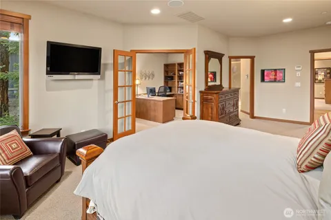 a bedroom with furniture and a flat screen tv