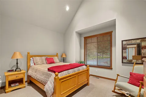 a bed sitting in a bedroom next to a window