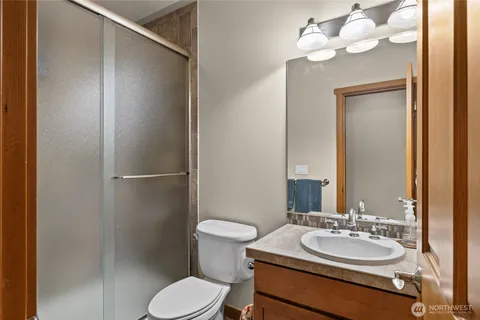 a bathroom with a sink vanity mirror and toilet