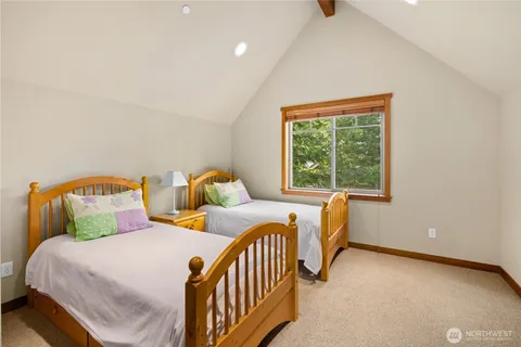 a bedroom with two beds and a window