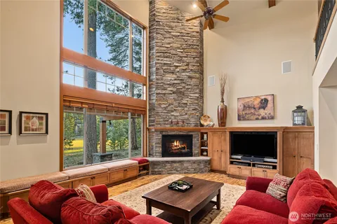 a living room with furniture a flat screen tv and a fireplace