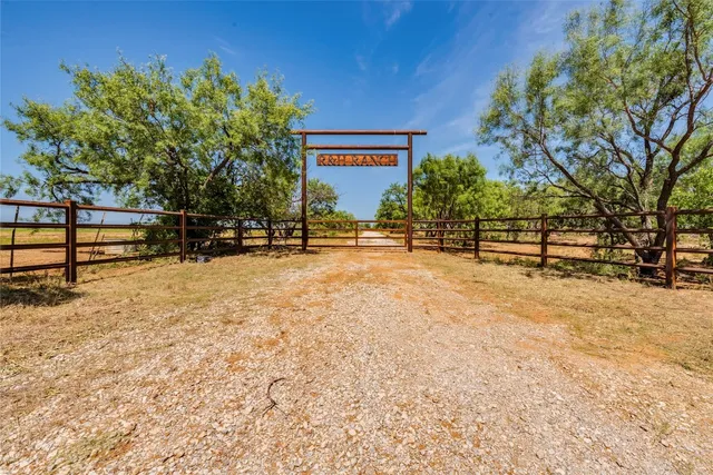 a view of a bench with wooden fence