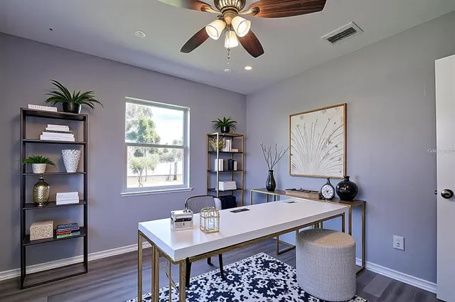 a view of a workspace with furniture and wooden floor