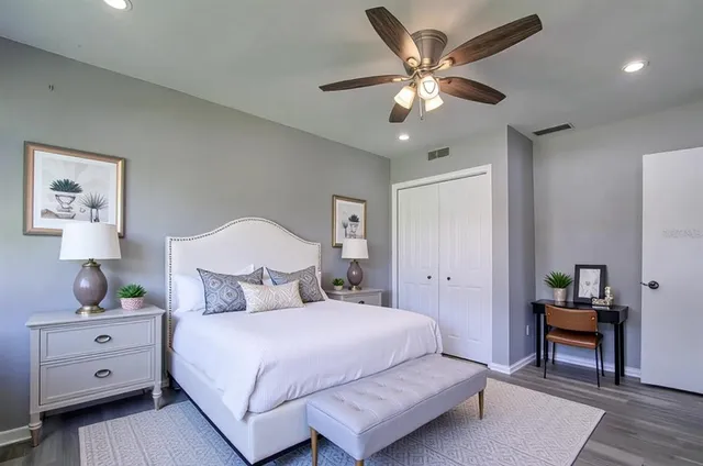 a bedroom with a large bed and a chandelier