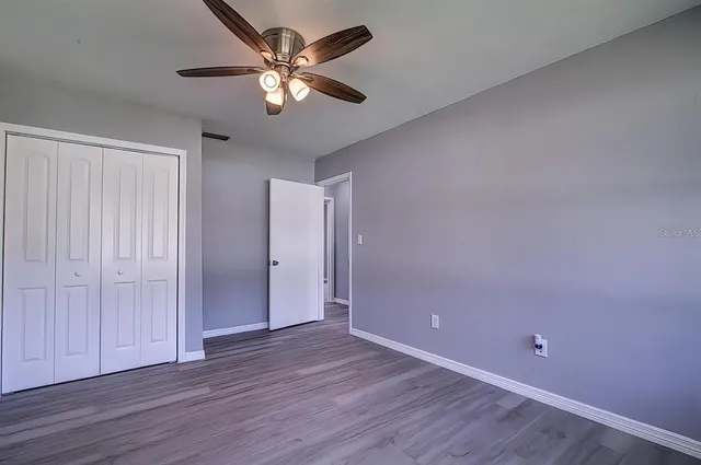 a view of an empty room with wooden floor