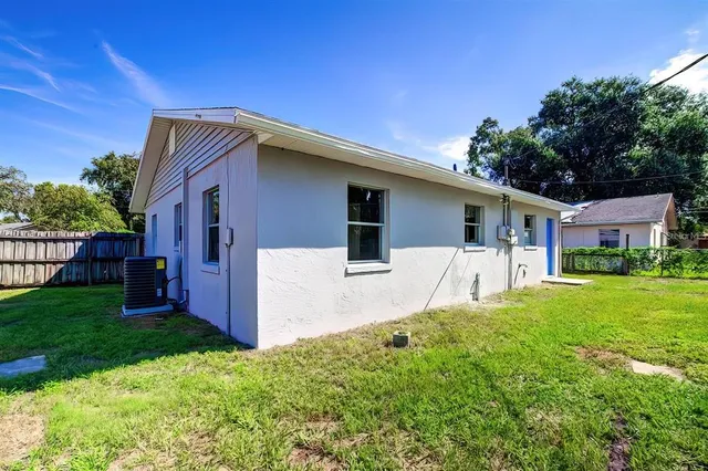 a front view of house with yard and green space