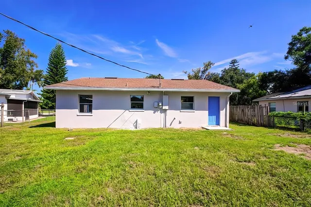 a front view of a house with a garden and yard