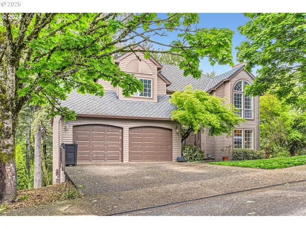 a house that has a tree in front of the house
