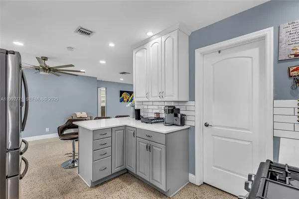 a kitchen with a sink appliances and cabinets