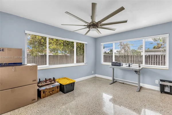 a view of a livingroom with furniture window and a ceiling fan