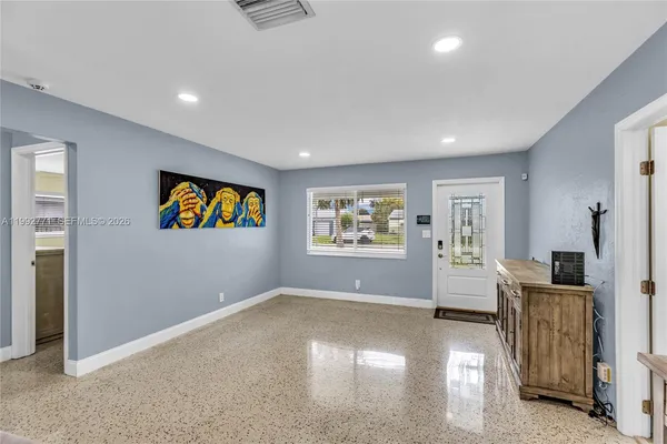 an empty room with windows and closet