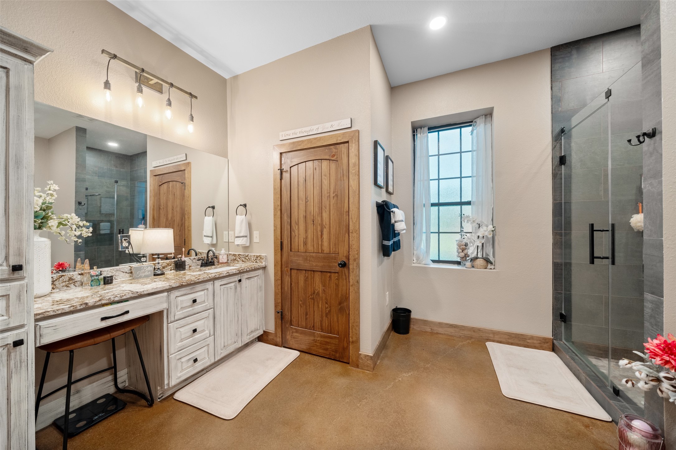 1402 Eagle Ferry Road Anahuac, TX 77514 - Photo 32 of 48 a large bathroom with a granite countertop sink a toilet a mirror and shower
