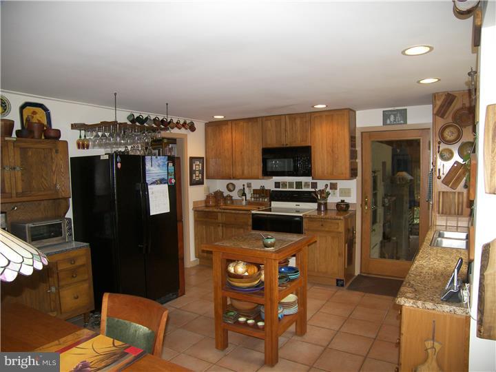 39 Bright Road Hatboro, PA 19040 - Photo 7 of 24 a kitchen with refrigerator and cabinets
