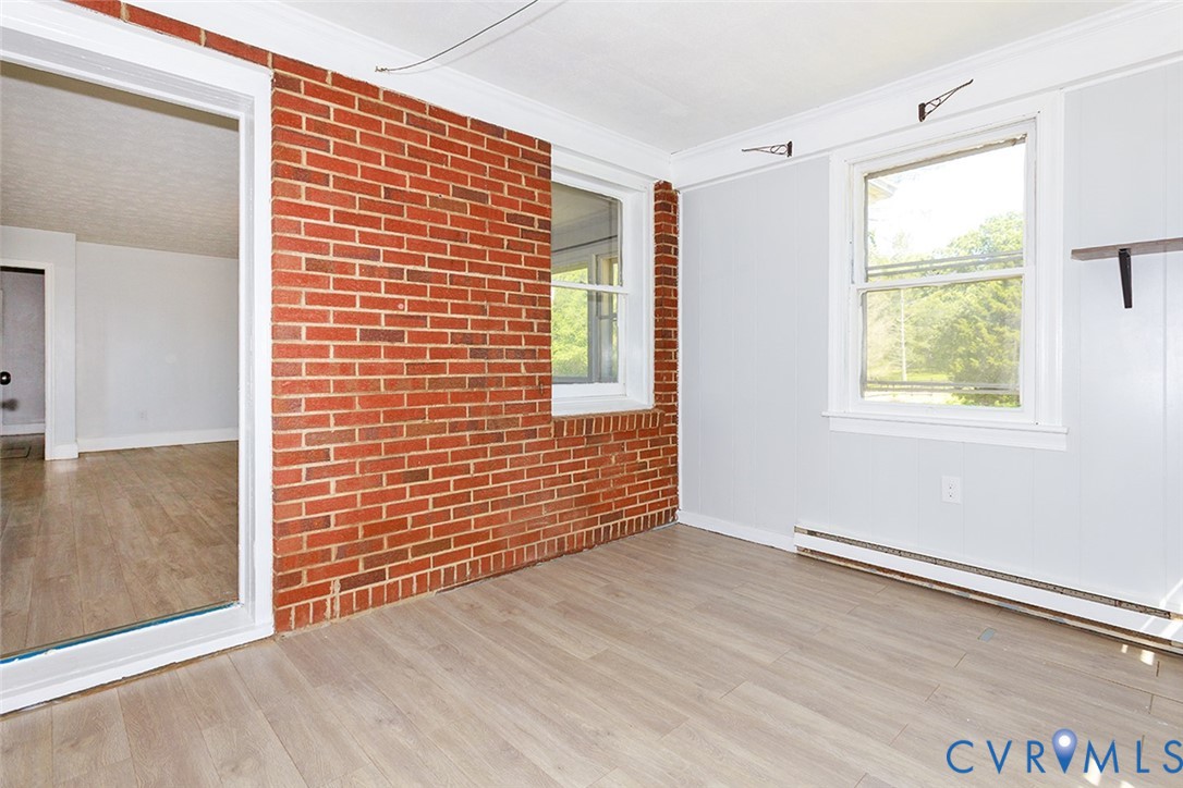 9903 Boze Road Ford, VA 23850 - Photo 8 of 45 a view of an empty room with wooden floor and a window