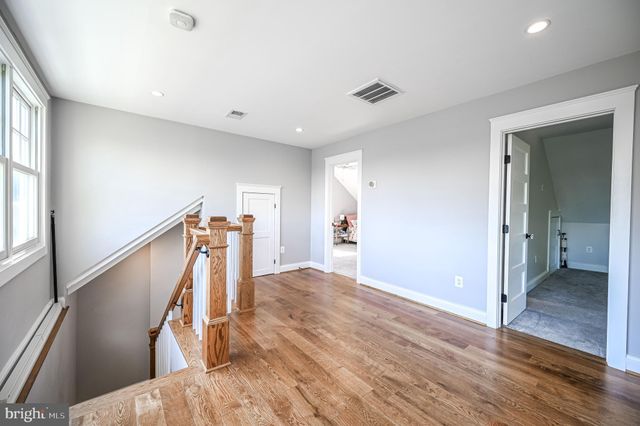an empty room with a ceiling fan and a window