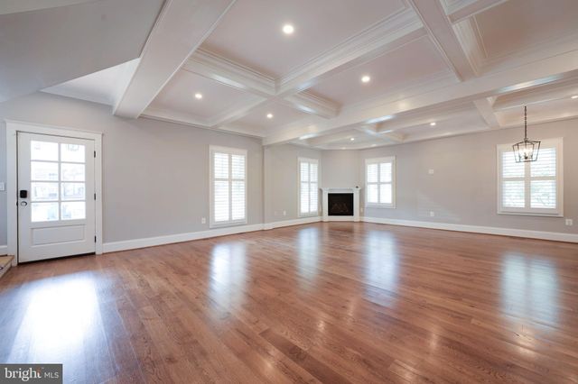 a large kitchen with stainless steel appliances kitchen island granite countertop a refrigerator and a stove top oven