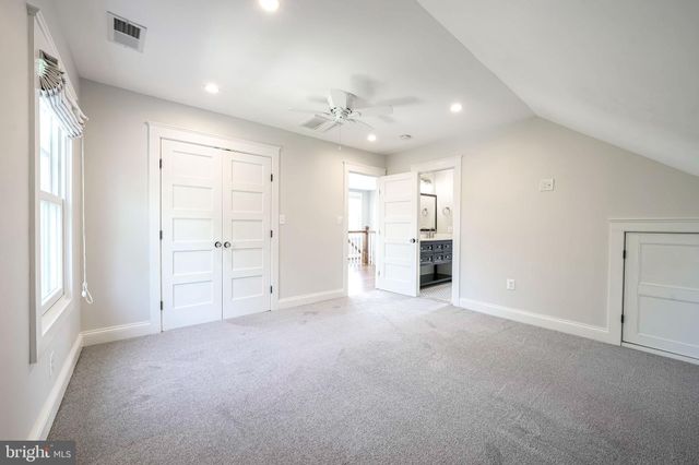 an aerial view of residential house with outdoor space and trees all around