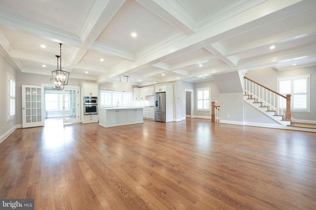 a large white kitchen with a large window